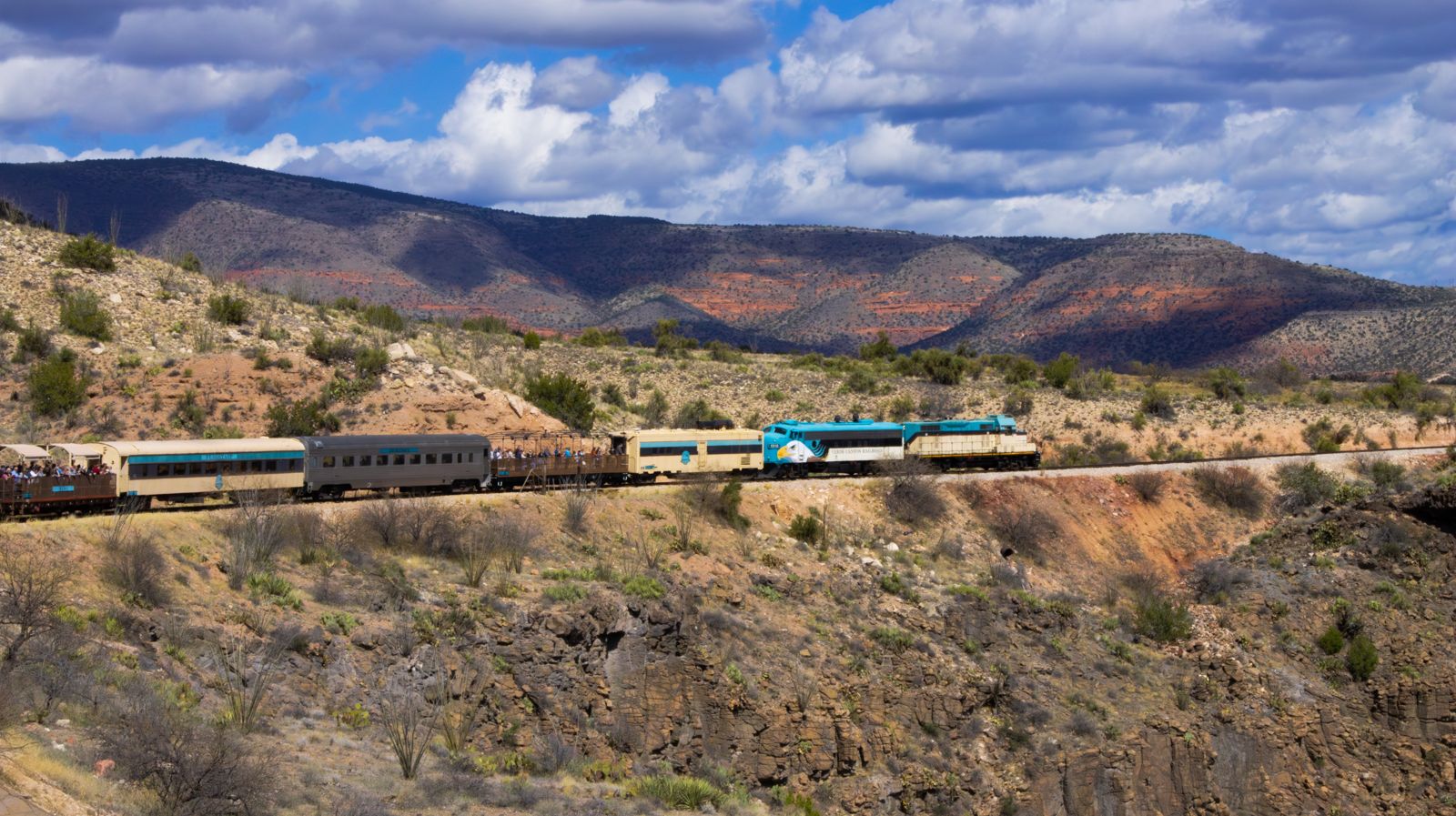 A tourist train crossing desert hills in Verde Canyon